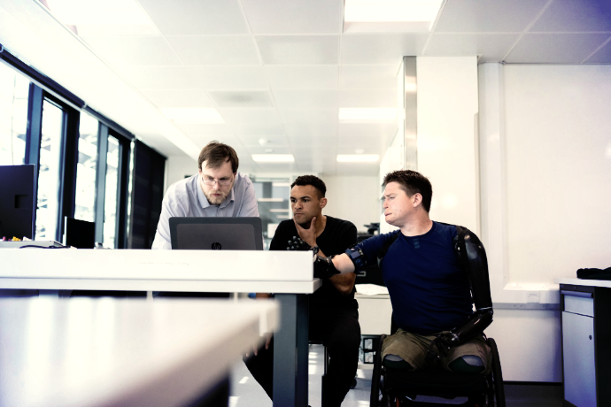 man in blue dress shirt sitting on black office rolling chair